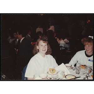 A girl smiling for the camera while seated at the "Recognition Dinner at Harvard Club"