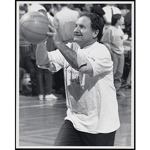 Tom Kershaw, owner of the Bull & Finch Pub on Beacon Street and the Hampshire House, holding a basketball ready to shoot at a fund-raising event held by the Boys and Girls Clubs of Boston and Boston Celtics