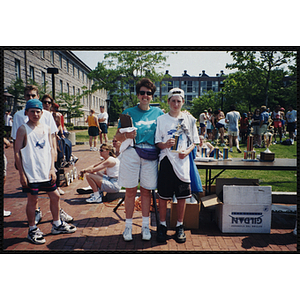 A women poses with a boy holding a trophy at the Battle of Bunker Hill Road Race