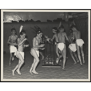 Small group of boys in the Indians Club dancing in a circle while playing drums