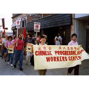 Two women from the Chinese Progressive Association Workers' Center participate in a march in Boston boycotting poison grapes
