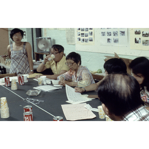 Members of the Chinese Progressive Association hold a meeting a table at their office