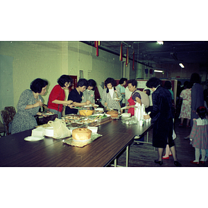 Guests and buffet at Andy's Garment Workers Food Service Graduation