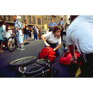 EMTs intern Jennifer Joy unloads medical supplies to assist an injured bicyclist