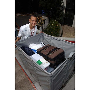 Odalis David Polanco pushes a full bin during move-in