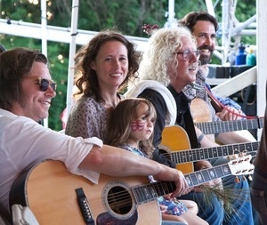 Johnny Irion, Sarah Lee Guthrie with young girl, Arlo Guthrie, and Tao Seeger on stage at the Clearwater Festival