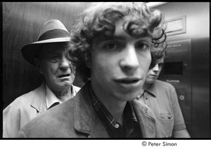 Stephen Davis in elevator, with older man in the background