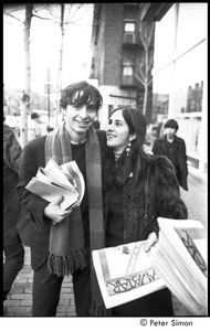 Stephen Davis and unidentified woman buying copies of Avatar magazine from a hawker