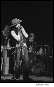 Bob Dylan performing on harmonica at the Harvard Square Theater, Cambridge, with the Rolling Thunder Revue