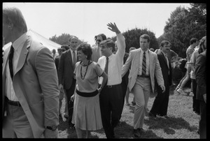 Kitty and Mike Dukakis (hand over face) walking hand-in-hand at the 25th Anniversary of the March on Washington