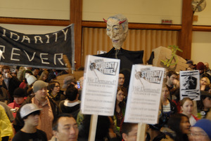 UMass student strike: strikers in the Student Union ballroom holding signs supporting a general student strike, 'Solidarity forever,' and a paper machie puppet