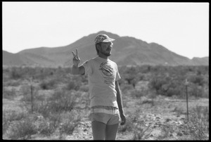 Peace encampment activist flashing peace sign near entrance to the Nevada Test Site