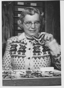 Marion E. Smith examining a butterfly specimen