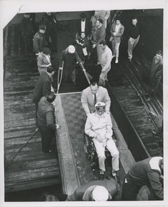 People going up ramp to board ship