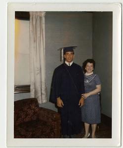 Robert Mello posing in graduation gown, with Deolinda Mello