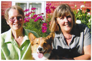 Kathleen, Malcolm, and Pam in front of cosmos in yard