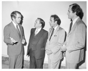 Photograph of Paul E. Tsongas speaking to three males