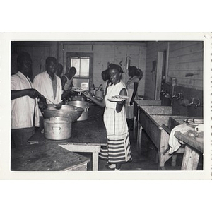 Staff members prepare food in the kitchen of Breezy Meadows Camp