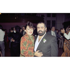 Couple in formal wear pose for the camera.