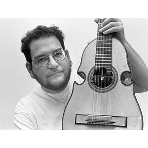 Man holding a cuatro, a guitar-like instrument of Puerto Rico.