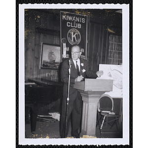 A man gestures at the podium during the Kiwanis Club's Bunker Hill Postage Stamp Luncheon