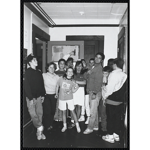 Site coordinators Josh Kraft and Liz Cinquino gather with a group of children in a room for the Tri-Club slide show at the Charlestown Clubhouse