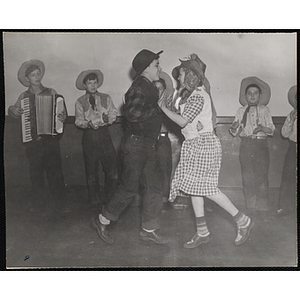 A girl and boy dance to the music of the Bunker Hillbillies