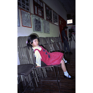 Child waits for a Chinese Progressive Association anniversary event to begin