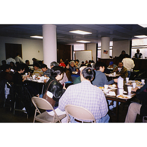 Guests eat Thanksgiving dinner at Association headquarters on 33 Harrison Avenue