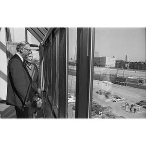 George and Lorraine Snell looking out the Snell Engineering Building window during dedication ceremonies