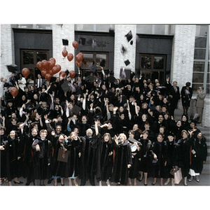 Law School graduates in caps and gowns posing on the steps of Ell Hall, 1986