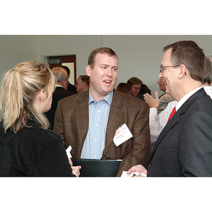 Todd Timbrook, '92, center, speaks with other guests at the NU Today Cancer Research Panel luncheon