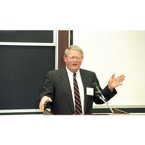 Neal Finnegan speaks at a podium at the College of Business Administration's 75 Year Symposium