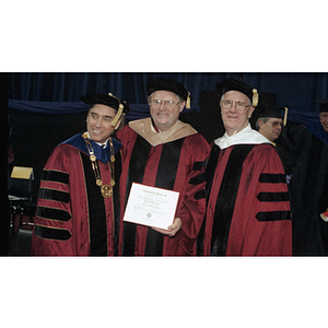 President Freeland, Neal F. Finnegan, and George Matthews pose together at commencement