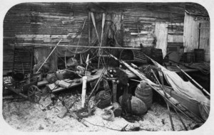 Fishing and clamming equipment against delapidated wall, Biddeford Pool, Maine, 1883