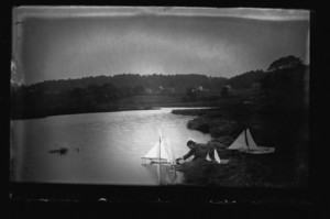 Two Curtis boys sailing model yachts, Manchester, Mass., undated