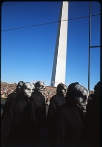 Performers from Bread and Puppet Theater in grotesque masks march past the Washington Monument: Washington Vietnam March for Peace