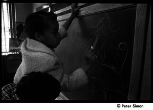 Children drawing on a blackboard, the Liberation School