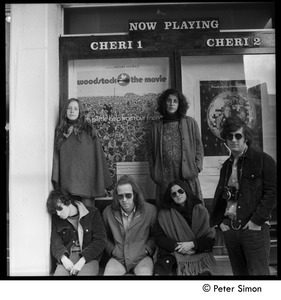 Group posed beneath the Woodstock movie poster, Cheri theater