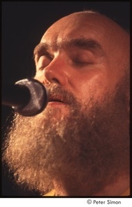 Ram Dass singing, on stage with Amazing Grace