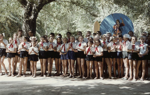 Schoolgirls standing in front of poster of traditional dancer