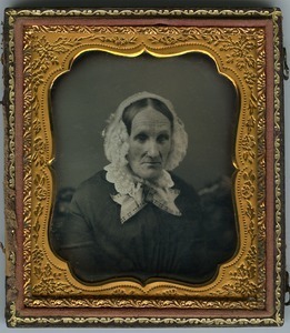 Unidentified elderly woman: half-length studio portrait, seated, wearing bonnet