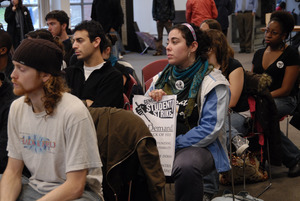 UMass student strike: audience in the Student Union ballroom with sign advocating a general student strike