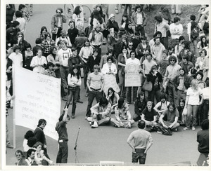 Board of Trustees fee increase demonstration: Economics professor Samuel Bowles speaking to protesters, Charles Bagli holding sign and raising middle finger