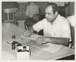 Felix Reyes practices lettering at TOWER training