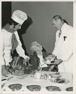 Unidentified man serving Thanksgiving dinner to a client