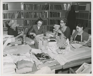 Women volunteers wrapping gifts for patients
