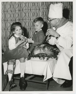 Chef carving turkey for young clients at Thanksgiving dinner