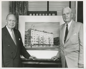 Jeremiah Milbank Sr. and Bruce Barton posing with an illustration of prospective building plans