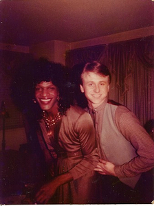 A Photograph of Marsha P. Johnson Wearing a Formal Brown Long Sleeve Dress Posing with Roommate